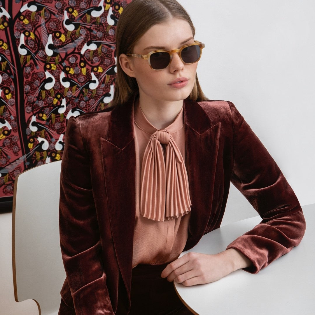 a woman is wearing glasses and a tie