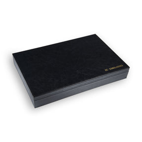 a black laptop sitting on a white surface 